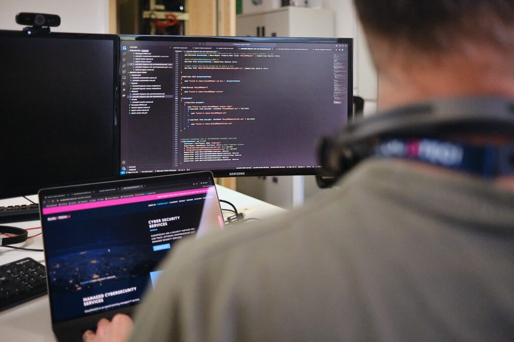 IT technicians working at his desk with headphones